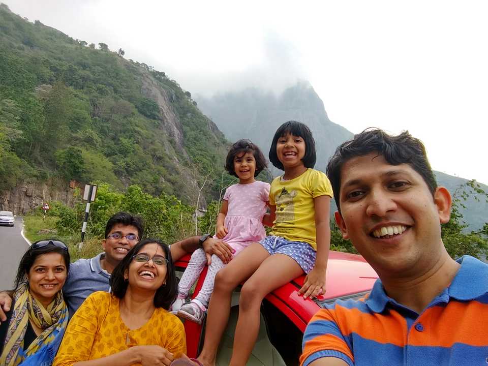 Smiling travelers in front of the Western Ghat mountains