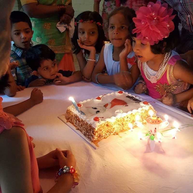 The obligatory routine of blowing candles on the birthday cake!