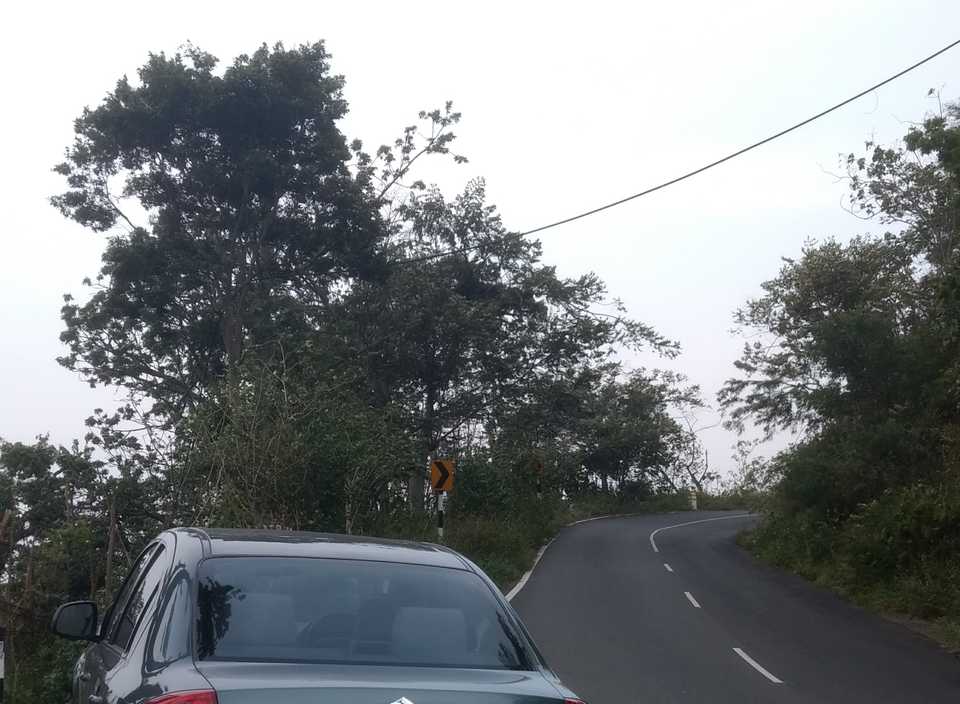 A car parked on the side of a ghat road