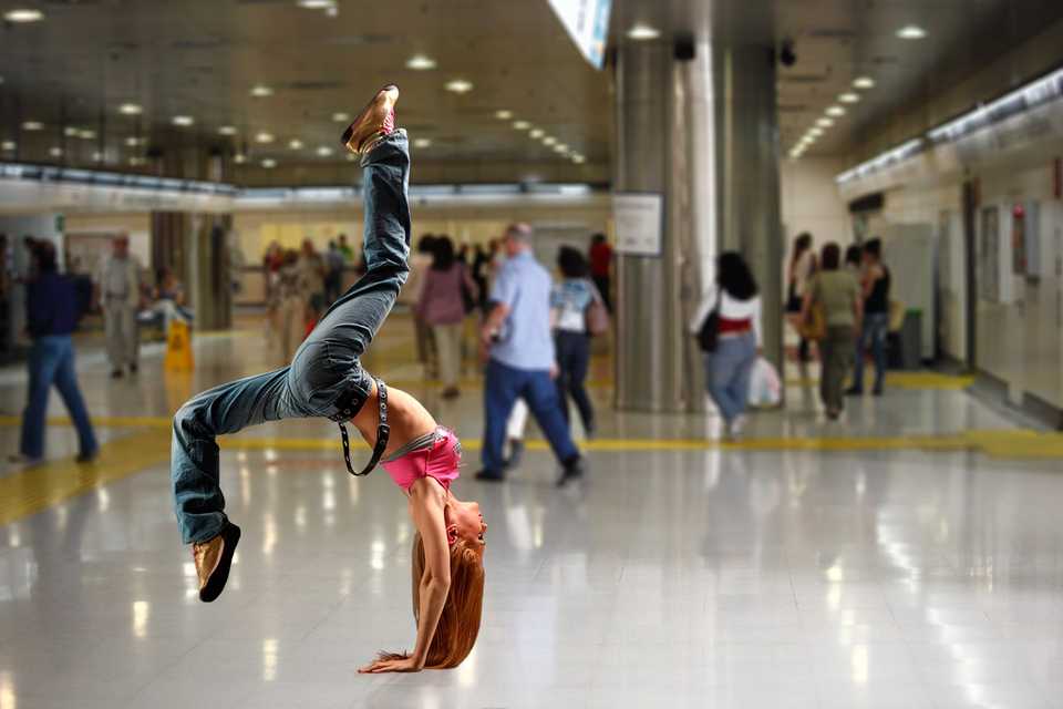 Girl doing a hand-stand in a public place